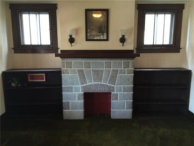 Stone fireplace with sconces and handmade bookshel