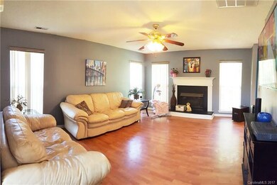 Spacious living room with gas fireplace and lamina