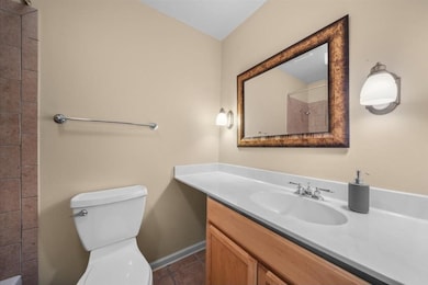 Bathroom with vanity, a shower, and tile patterned floors
