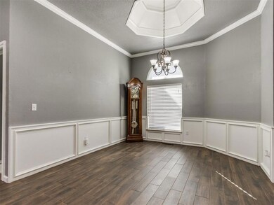Formal dining room featuring a wainscoted wall, da