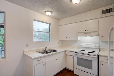 Kitchen featuring white appliances, under cabinet