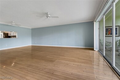 Empty room with ceiling fan, crown molding, and wo