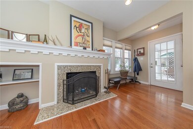 The Living Room with granite surround fireplace and showing the front entryway to the right
