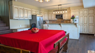 Dining room featuring dark wood finished floors and a textured ceiling