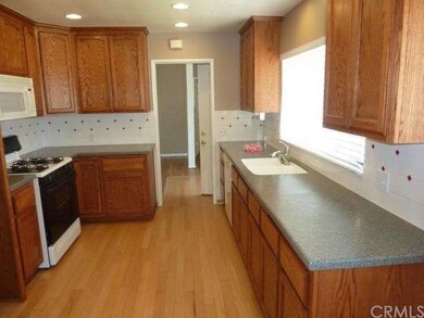 Oak cabinets, corian counters with decorative tile