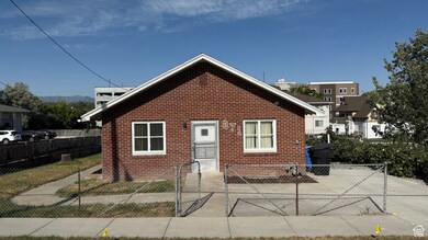 Bungalow-style house with brick siding and a gate
