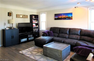 Living room with dark hardwood / wood-style floors