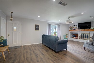 Living room with crown molding and dark wood-type 