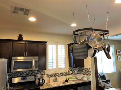 KITCHEN VIEW OF GRANITE COUNTER TOPS AND BACK SPLA