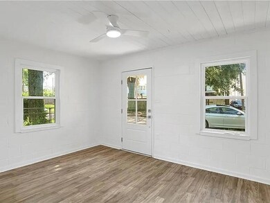 Unfurnished room with wood finished floors, healthy amount of natural light, concrete block wall, and wood ceiling