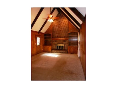Family room features vaulted ceiling, wood-burning