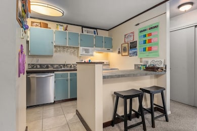 Kitchen featuring stainless steel dishwasher, blue