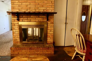 Fireplace between dining and kitchen area