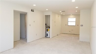 Living room & kitchen with view to hallway leading