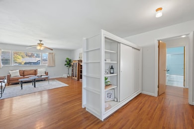 Living area featuring light wood-style flooring and a ceiling fan