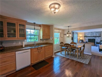 Kitchen with Custom Cabinetry and Gleaming Wood Fl