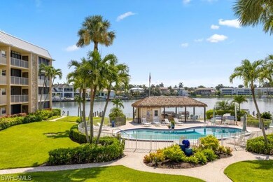 Community pool with a gazebo, a water view, and a patio