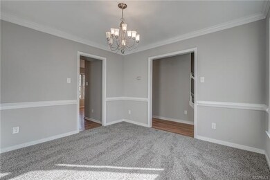 Dining Room with Carpet, Chandelier, Crown Molding