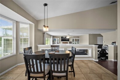 Dining room featuring light tile patterned floors and lofted ceiling