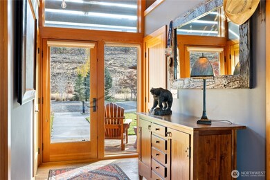 The light-filled main entry includes generous coat closets, hardwood floors and views to and from the home.