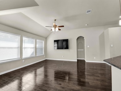 Unfurnished living room featuring ceiling fan, lof