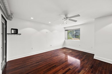 Spare room with a ceiling fan, baseboards, recess