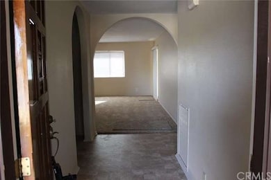 Front door and foyer, with kitchen to the left and