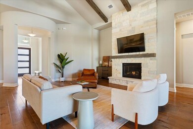 Living room with visible vents, beam ceiling, a s