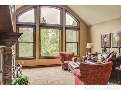 Vaulted great room with huge windows looking out t