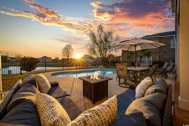 Pool at dusk featuring an outdoor living space wit