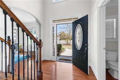 Entryway with baseboards, arched walkways, plenty 