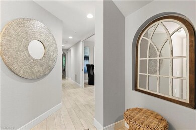 Hall featuring arched walkways, baseboards, recess