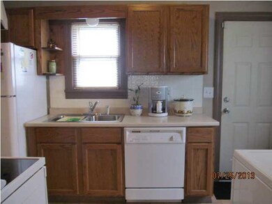 Kitchen complete with dishwasher and window over s