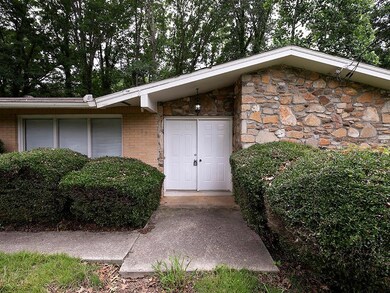 Entrance to property with brick siding and stone siding