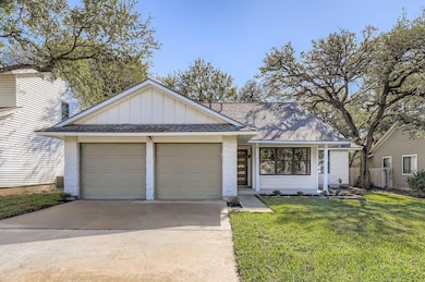 Ranch-style home featuring board and batten siding, concrete driveway, roof with shingles, a front lawn, and a garage