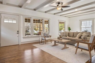 Walking into a oversized living area with windows 