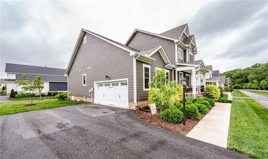 View of home's exterior featuring driveway, a yard