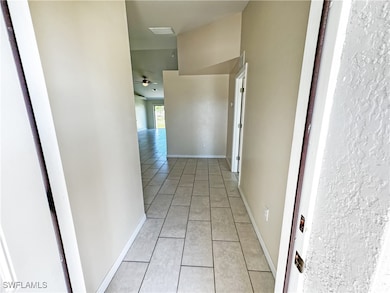 Hallway featuring light tile patterned floors