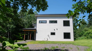 Back of house featuring a lawn
