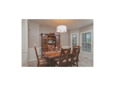 Elegant dining room off front entry with bay windo