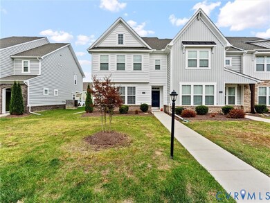 View of front of home with board and batten siding and a front yard
