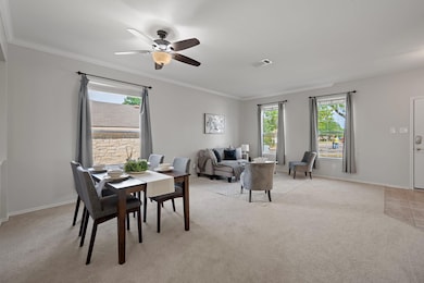 Dining space featuring light colored carpet, crow
