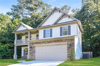 Craftsman-style house featuring a balcony, stone siding, concrete driveway, and a garage