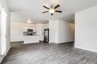 Unfurnished living room featuring dark wood-type f