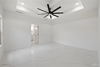 Empty room featuring ceiling fan, recessed lighting, and light marble finish flooring