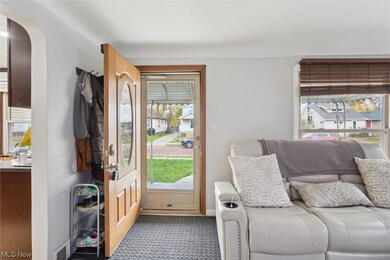 Living room with dark carpet and plenty of natural light