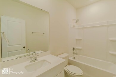 Full bathroom with toilet, vanity, and tub / showe