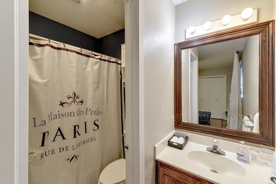 Full bath featuring vanity, toilet, and curtained