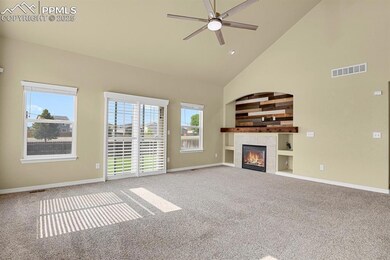 Inviting, open living concept with vaulted ceiling and cozy fireplace.