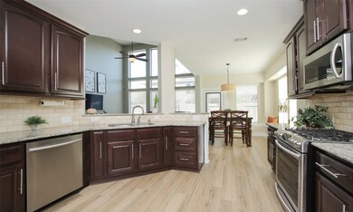 This kitchen offers granite counter tops, stainless steel appliances, gas range & hardware on the 42-inch Kent Moore cabinetry.